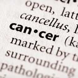 Image of definition of cancer, with the word cancer bolded and the rest of the text faded out to emphasize the word cancer.